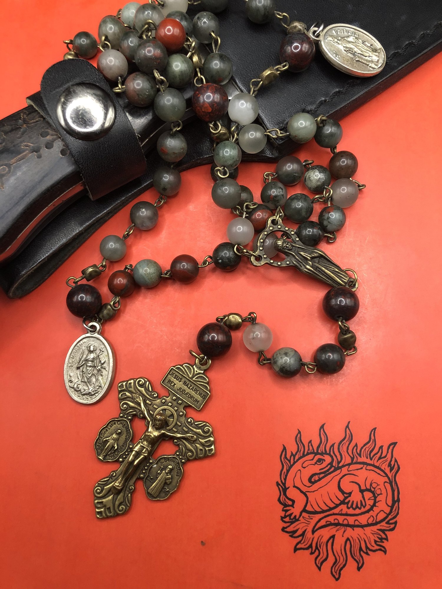 Bloodstone rosary dedicated to St. Martha on a Solomonic black handled knife and a copy of Grimoire Verum